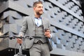 Confident young businessman with his bicycle drinking coffee outdoors. Royalty Free Stock Photo