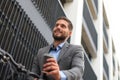 Confident young businessman with his bicycle drinking coffee outdoors. Royalty Free Stock Photo