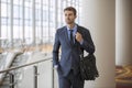 Confident Young Businessman at Hotel by Escalator business trip Royalty Free Stock Photo