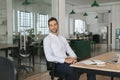 Confident young businessman sitting at his desk in an office Royalty Free Stock Photo