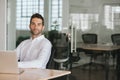 Confident young businessman sitting at his office desk Royalty Free Stock Photo