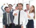 Confident young businessman standing in front of a happy busines