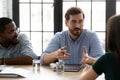 Confident young businessman wearing glasses speaking at corporate meeting Royalty Free Stock Photo