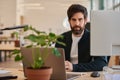 Confident young businessman working on a laptop at his office desk Royalty Free Stock Photo