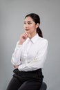 Confident young businesswoman sitting on isolated background. Enthusiastic Royalty Free Stock Photo