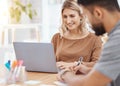 Confident young caucasian businesswoman working on a laptop in an office boardroom. Happy entrepreneur planning online Royalty Free Stock Photo