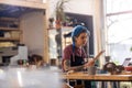 Young woman using laptop in her workshop Royalty Free Stock Photo