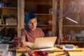 Young woman using laptop in her workshop Royalty Free Stock Photo