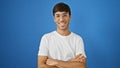 Confident young hispanic man wearing glasses and looking cool, standing with a cheerful smile and positive expression against an Royalty Free Stock Photo