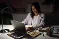 Confident Young Indian Mixed-race Businesswoman Working in Office at Night. Girl Working Overtime Royalty Free Stock Photo