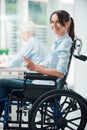 Smiling disabled woman with smart phone