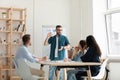 Focused diverse employees listening to leader lecturer in office. Royalty Free Stock Photo