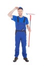 Confident young male cleaner holding mop