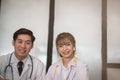 Confident young male & female doctor smiling at camera. Portrai Royalty Free Stock Photo