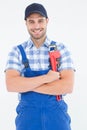 Confident young male repairman holding adjustable spanner Royalty Free Stock Photo