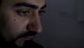 Confident young man looking at a monitor screen. HDR. Close up of a serious businessman face working late on computer in Royalty Free Stock Photo