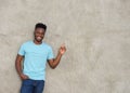 Confident young man pointing and smiling Royalty Free Stock Photo