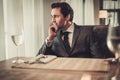Confident young man sitting in restaurant waiting for somebody Royalty Free Stock Photo