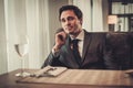 Confident young man sitting in restaurant waiting for somebody Royalty Free Stock Photo