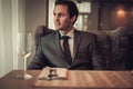 Confident young man sitting in restaurant waiting for somebody. Royalty Free Stock Photo