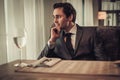 Confident young man sitting in restaurant waiting for somebody. Royalty Free Stock Photo