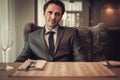 Confident young man sitting in restaurant waiting for somebody. Royalty Free Stock Photo