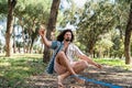 Young man slacklining in the city park during summer day