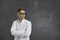 Confident young man in thug life glasses standing against grey copy space background Royalty Free Stock Photo