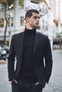 Confident young man walking on a European city street Royalty Free Stock Photo