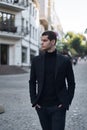 Confident young man walking on a European city street Royalty Free Stock Photo