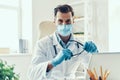 Confident young man in white lab coat and protective mask Royalty Free Stock Photo