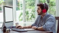 Confident young man working and concentrate on monitor while sitting at his working place in office Royalty Free Stock Photo