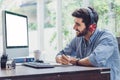 Confident young man working and concentrate on monitor while sitting at his working place in office Royalty Free Stock Photo