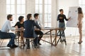 Confident young multiethnic speaker woman presenting sales report Royalty Free Stock Photo