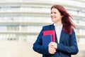 Confident young smiling student outdoors holding books Royalty Free Stock Photo