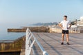 Confident young spotrsman standing on pier Royalty Free Stock Photo