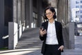 Confident young successful business woman standing outside an office center and courthouse, holding her hand in her suit Royalty Free Stock Photo