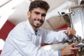 confident young technician operating machine at modern brewery Royalty Free Stock Photo