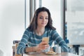 Confident young woman at the cafe using a smartphone Royalty Free Stock Photo