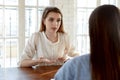 Confident young woman candidate answering employer questions at meeting Royalty Free Stock Photo