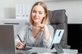 Confident young woman designer using graphic tablet laptop smartphone for work in home office workspace interior Royalty Free Stock Photo