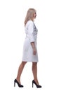 confident young woman doctor striding forward . isolated on a white background. Royalty Free Stock Photo