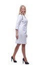 confident young woman doctor striding forward . isolated on a white background. Royalty Free Stock Photo