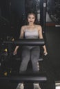 A confident young woman does leg extensions. Using a leg extension machine at the gym Royalty Free Stock Photo