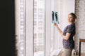 Confident young woman holding image of lungs x-ray in sunny day by window and looking at camera. Royalty Free Stock Photo