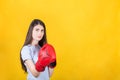 Confident young woman with red boxing gloves stands in fighting stance. Portrait of determined girl ready for battle isolated on Royalty Free Stock Photo