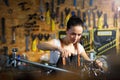 Young woman working in a bicycle repair shop