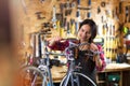 Young woman working in a bicycle repair shop Royalty Free Stock Photo