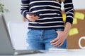 Confident young woman working in her office with mobile phone. Royalty Free Stock Photo