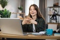 Confident young woman writing message during mobile conversation at office. Royalty Free Stock Photo